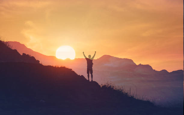 istock Men feeling strong and energized on mountain top at sunrise. 2166390075