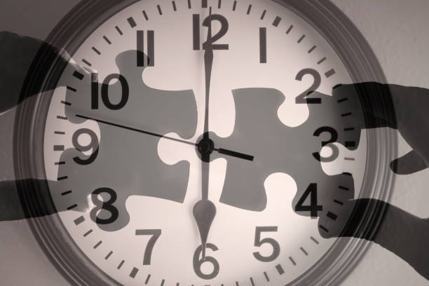 istock Hands joining puzzle pieces on clock background. 2166390085