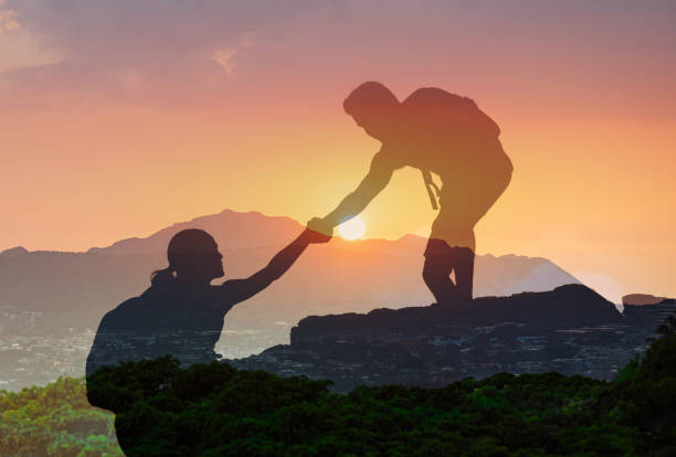 istock Man hiker helping his hiker friend. Helping hands. 2166390707
