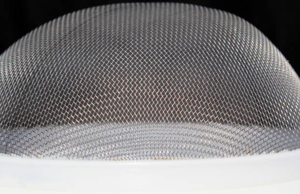 Close-up of fine mesh material on a kitchen strainer sifter