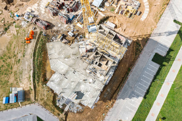 istock construction site with crane. new concrete apartment building under construction. aerial top view. 2166400396