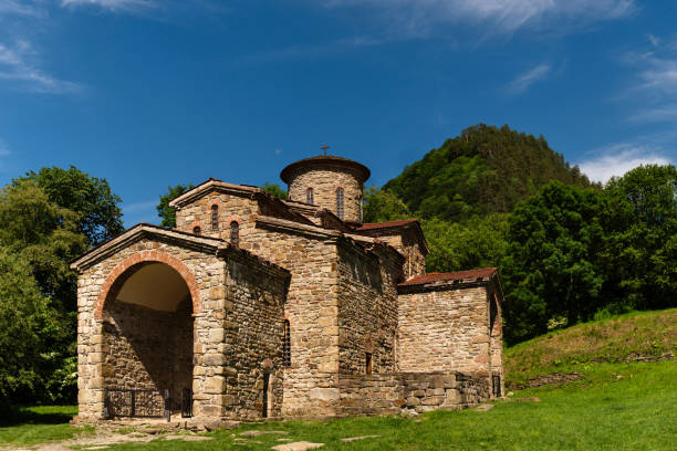 istock Ancient stone church set in green valley 2166402315