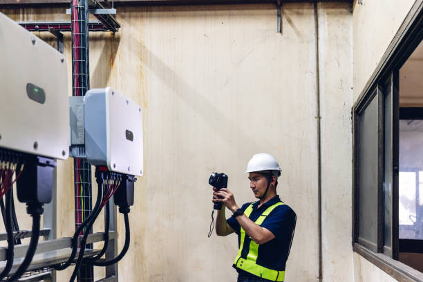 istock Inspector examination of photovoltaic modules using a thermal imaging camera. Engineer Checking Temperature the string cables input to inverter solar panel used thermos infrared. 2166402492
