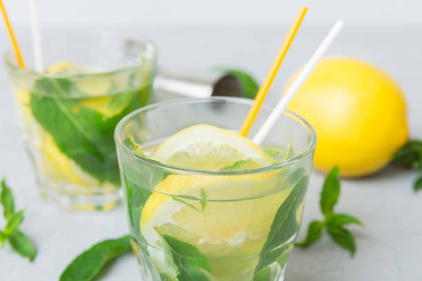 istock Mojito summer refreshing cocktail with ice and mint. mojito cocktail with lime, lemon and mint in a tall glass with a stick 2166405937