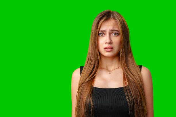istock Young Woman With Worried Expression Against Green Screen Background 2166406064