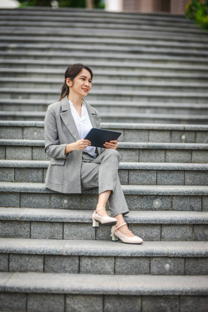 istock Cityscape Strategy: A Businesswoman’s Digital Focus in a Modern World 2166406312