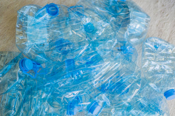 Two plastic containers of water are inside a transparent plastic bag. Fresh.  Freshness. Full. Gallon. Health. Healthy. High. Home. Label. Large. Liquid. Mineral. New. Object.