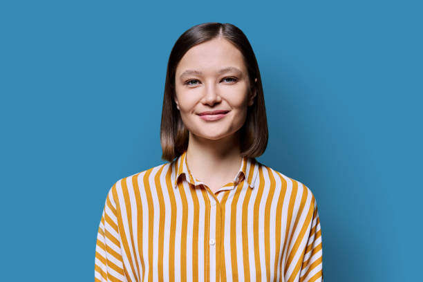 istock Young smiling attractive woman on blue background 2166407461