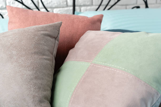 istock Soft Colorful Pillows on a Blue Bed With Black Metal Headboard 2166407704