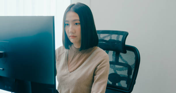 istock Young adult Asia female freelance typing write prompt AI bot IT app smart program nomad, video game, terminal with coding language, user interface, designer, big data center on computer. 2166408521