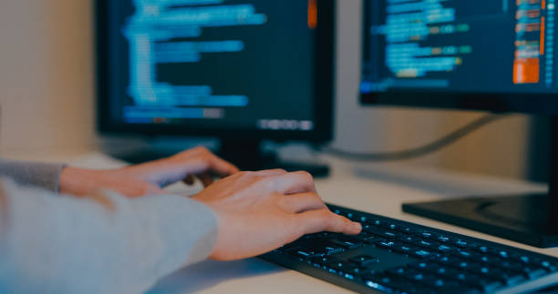 istock Closeup young Asia female freelance typing write prompt AI bot IT app program nomad, video game, terminal with coding language, designer, big data center on desktop computer in night office. 2166408615