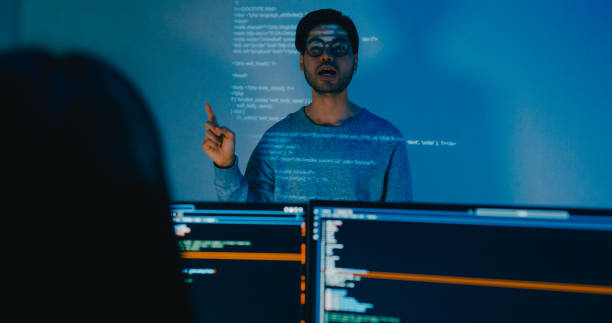 istock Group Asia male software developers mentor leader manager talk strategy plan to executive write prompt AI bot IT app program nomad, video game, designer, data center. Projecting slideshow code. 2166408626