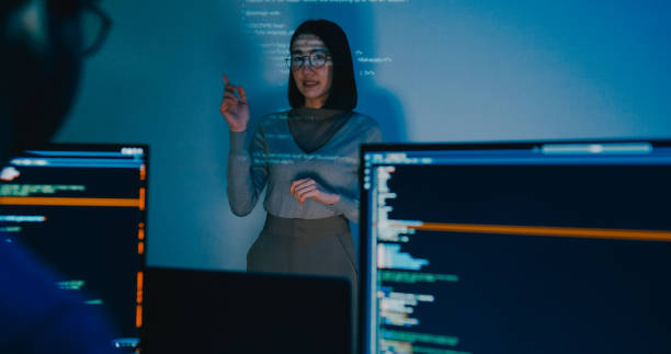 istock Group Asia female software developer mentor leader manager talk strategy plan to executive write prompt AI bot IT app program nomad, video game, designer, data center. Projecting slideshow code. 2166408640