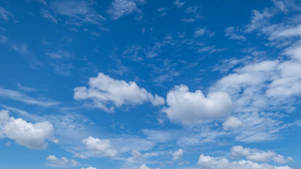 istock Panoramic view of clear blue sky and clouds, Blue sky background with tiny clouds. White fluffy clouds in the blue sky. Captivating stock photo featuring the mesmerizing beauty of the sky and clouds. 2166411723