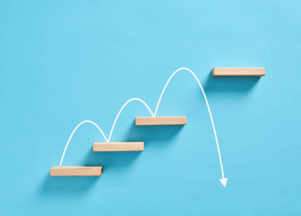 istock Wooden blocks arranged as stairs with a curve jumping over one step on blue background 2166412367