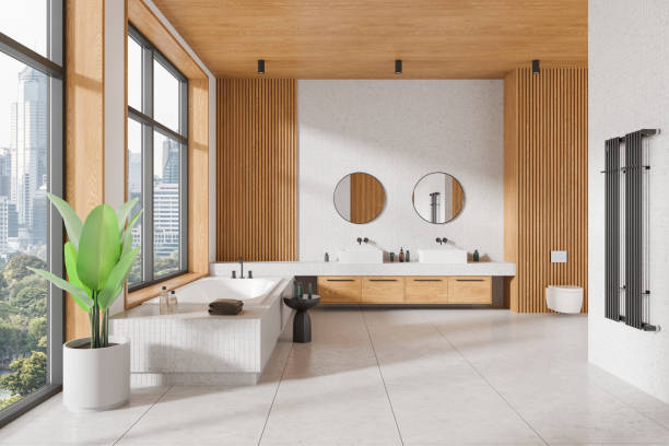 istock Modern bathroom interior featuring a bathtub, sinks, mirrors, and plants. Contemporary design. Urban city view. Spacious and stylish concept. 3D rendering 2166412416