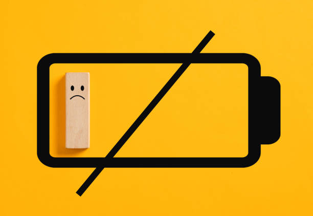 Empty battery symbol with a sad face is representing the concept of emotional exhaustion and burnout. Discharged, flat or empty battery.