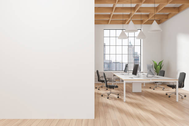 istock Modern office interior with a blank white wall on the left and a sleek open space with desks and computers on the right, with a city view background. Mockup concept. 3D Rendering 2166413252