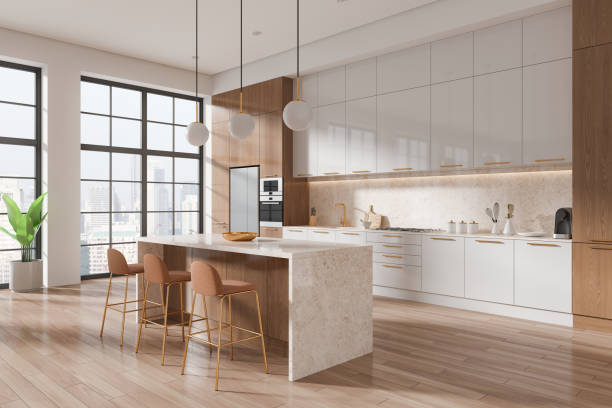 istock Modern kitchen with white and wood details, featuring an island, bar stools, and large windows. Light-filled room concept. 3D Rendering 2166413355