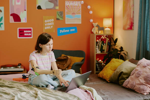 istock Girl With Disability Texting On Laptop 2166413356