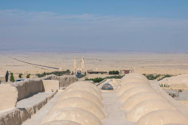 istock Remote Desert Monastery with Domed Roofs and Vast Landscape 2166413848