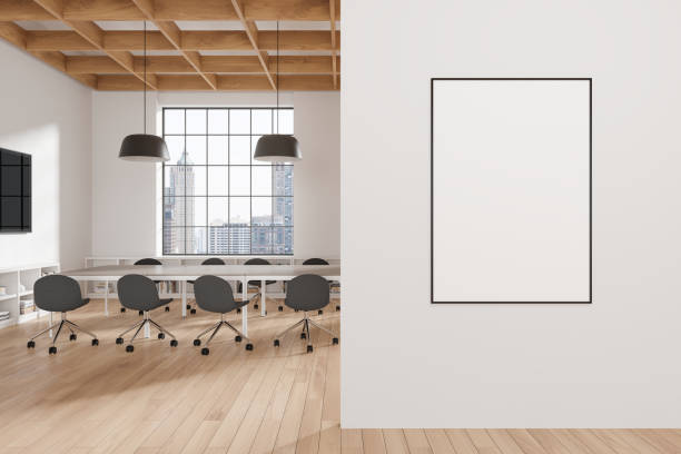 istock Cozy office interior with meeting table and tv screen, window and mockup frame 2166413881