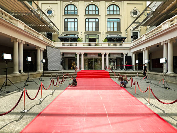 istock Workers preparing red carpet area for media event 2166413936