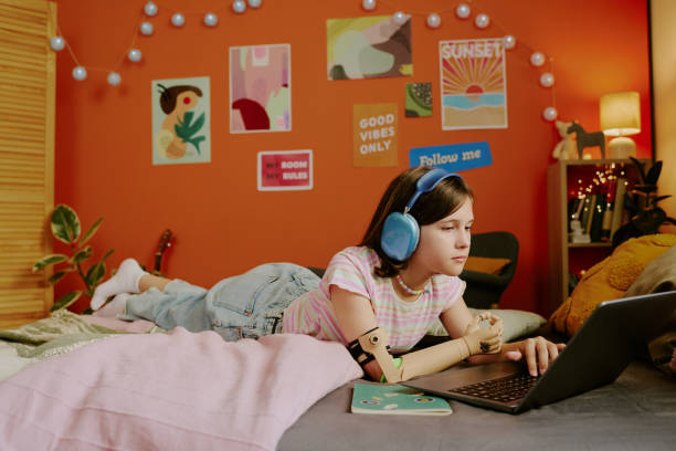 istock Teenager In Headphones Using Laptop 2166413949