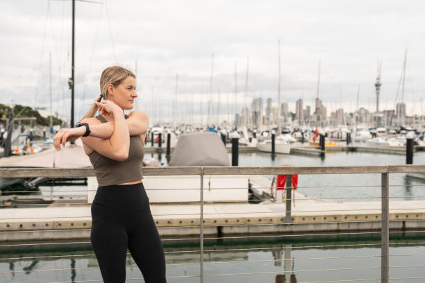 istock Young Female Athlete Stretching Outdoors 2166415040