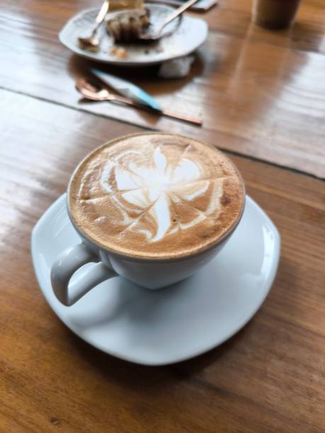 istock latte coffee cup on a wooden table The scene is cozy 2166415126