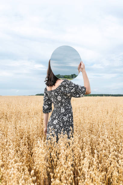 istock Woman and Mirror in Wheat Field 2166415279
