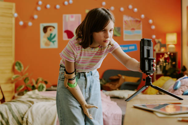 Girl Adjusting Smartphone On Tripod