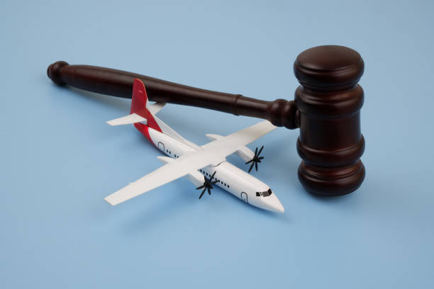 istock Wooden judge gavel and airplane model on blue background. 2166416549