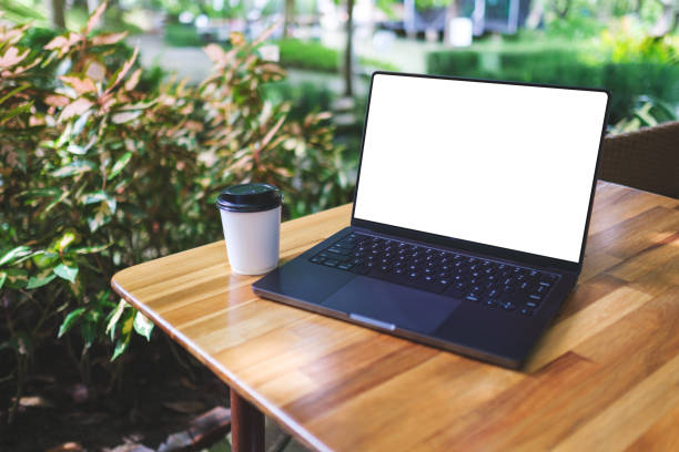 istock Mockup image of a laptop computer with blank white desktop screen and coffee cup on the table in the outdoors 2166416730