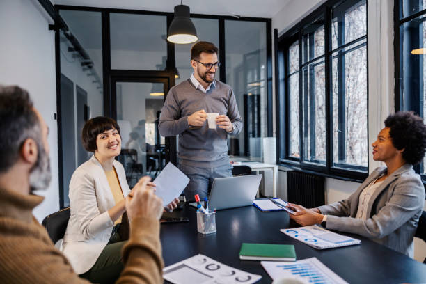istock A manager is smiling at his multicultural team at the meeting room. 2166416896