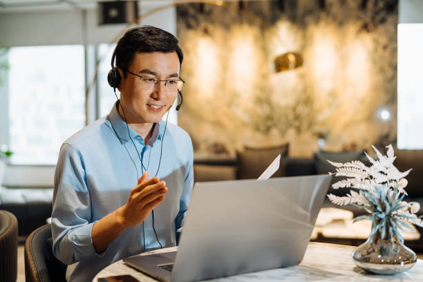 istock Asian businessman on videoconference with headset in modern office, capture the serious emotions. 2166416927