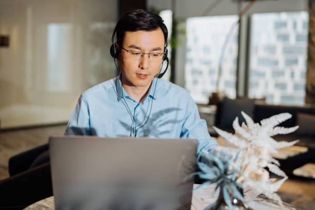 istock Asian businessman on videoconference with headset in modern office, capture the serious emotions. 2166417555