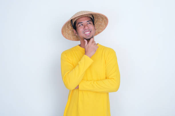 A farmer smiling happy when dreaming about something