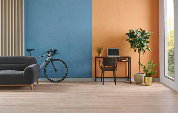 istock Modern working room interior home decoration, orange and blue textured wall background, vase of plant, bike. 2166418445