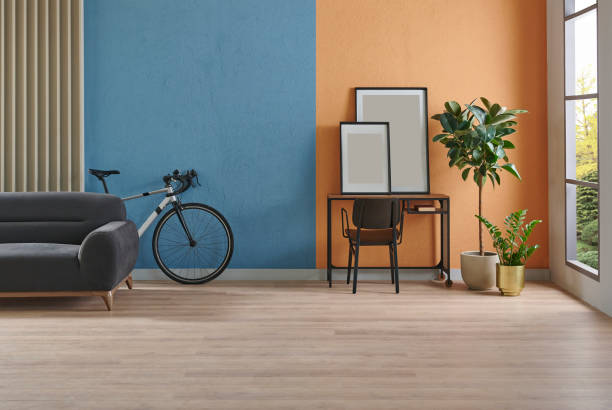 istock Modern working room interior home decoration, orange and blue textured wall background, vase of plant, bike. 2166418524