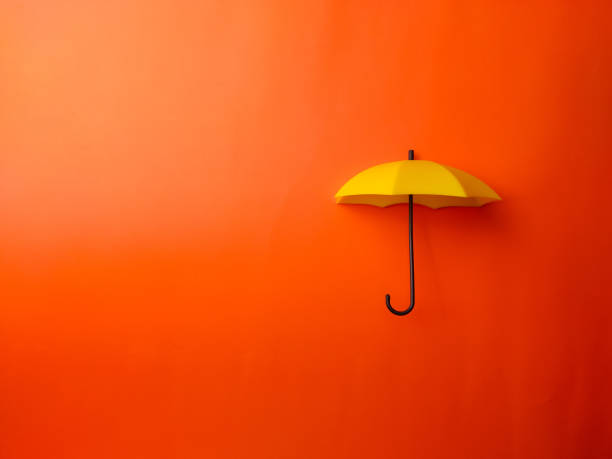 istock Top view yellow umbrella on a orange background 2166420311