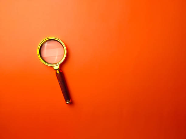 istock Top view vintage magnifying glass on a orange background 2166420312