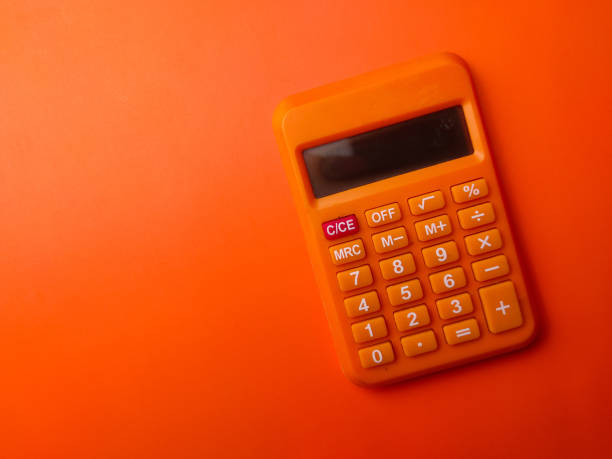 istock Top view orange calculator on a orange background 2166420314
