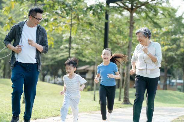 istock Asian family jogging exercise together at park 2166421480