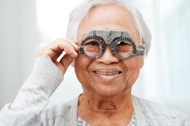 istock Asian senior woman wearing ophthalmic vision eye test and using optical trial frame. 2166421595