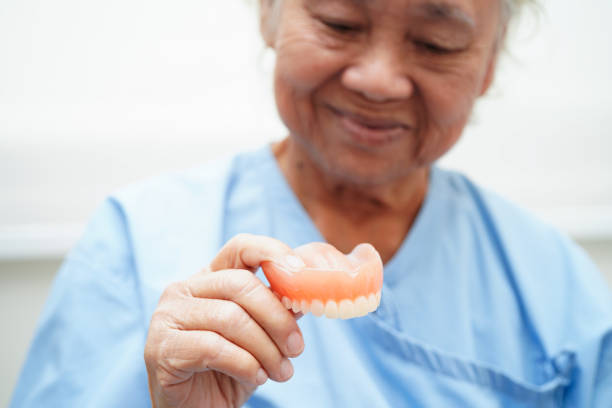 istock Doctor holding teeth denture in hand for dentist studying about dentistry. 2166421708