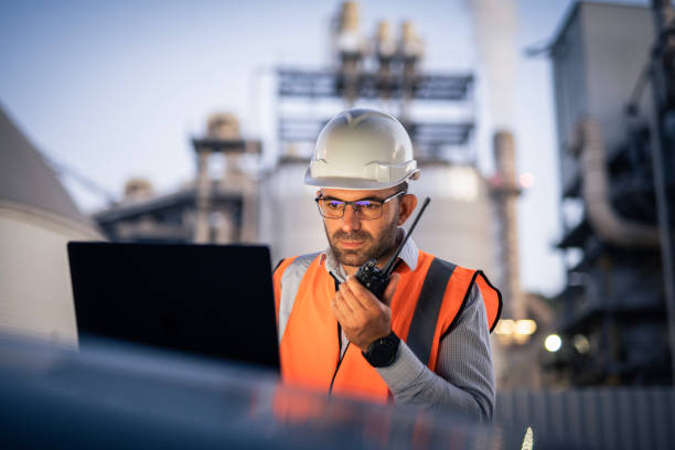 istock Serious handsome engineer using a laptop while working in the oil and gas industry 2166421896