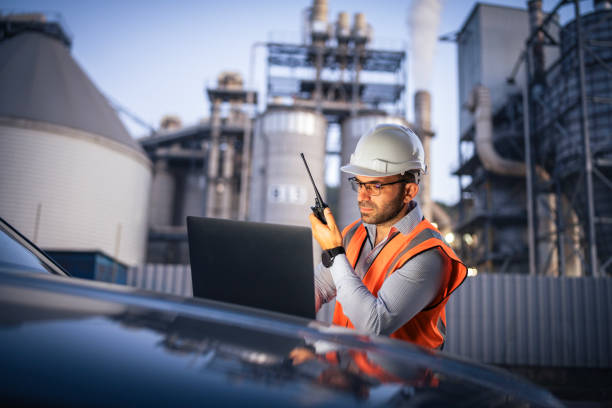 istock Serious handsome engineer using a laptop while working in the oil and gas industry 2166421906