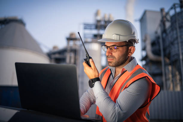 istock Serious handsome engineer using a laptop while working in the oil and gas industry 2166421908