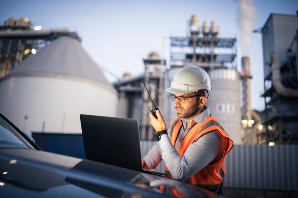 istock Engineer working with laptop and report a problem on walkie talkie. 2166421909